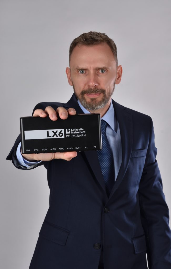 Ekspert wariografii trzymający w ręku wariograf Lafayette LX6